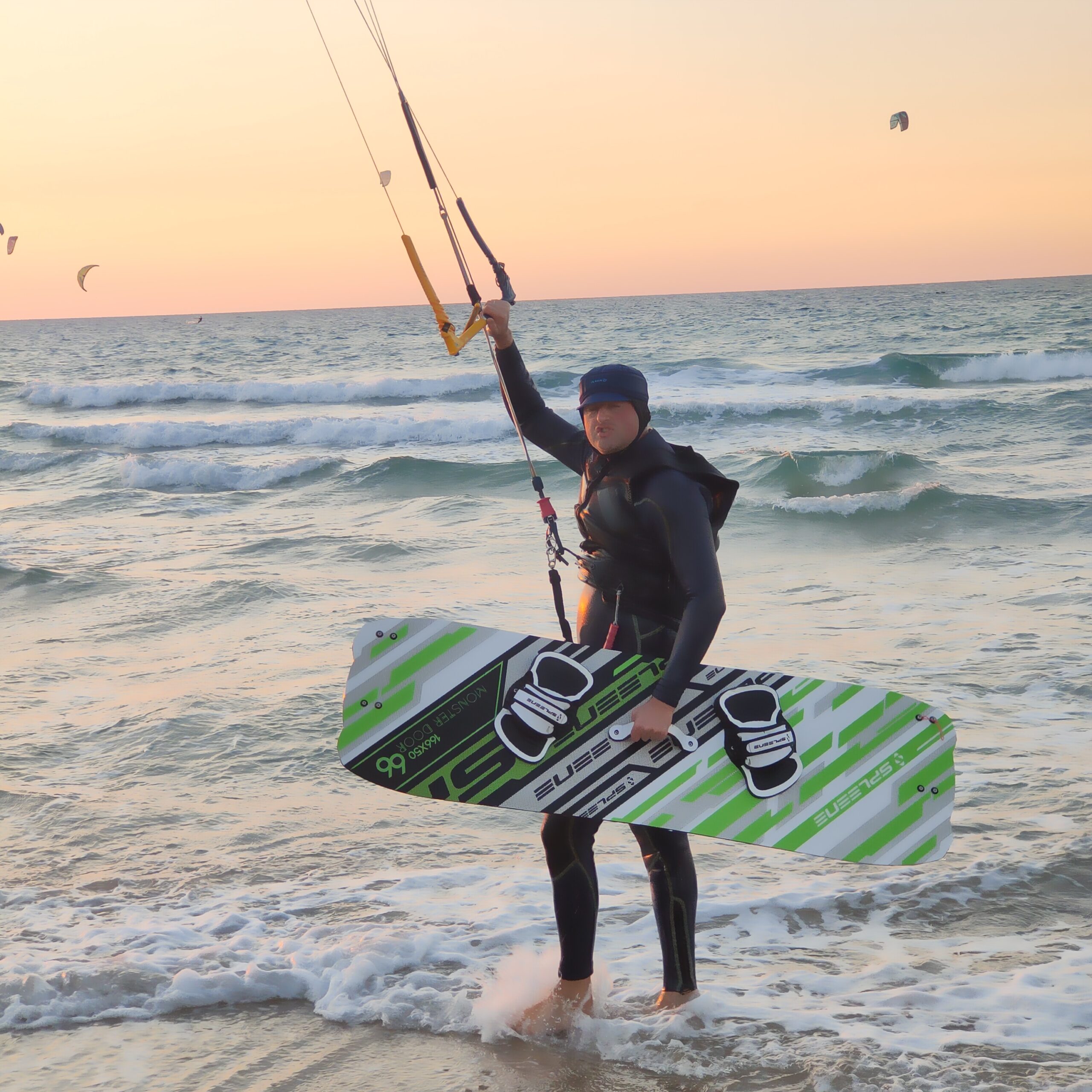 is kitesurfing hard showing beginner on beach with kite in the air learning to kitesurf