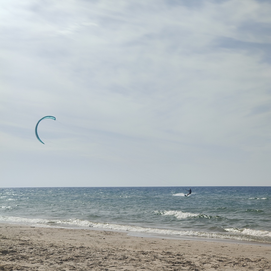 learn kitesurfing beginner getting first ride on board with kite in the air